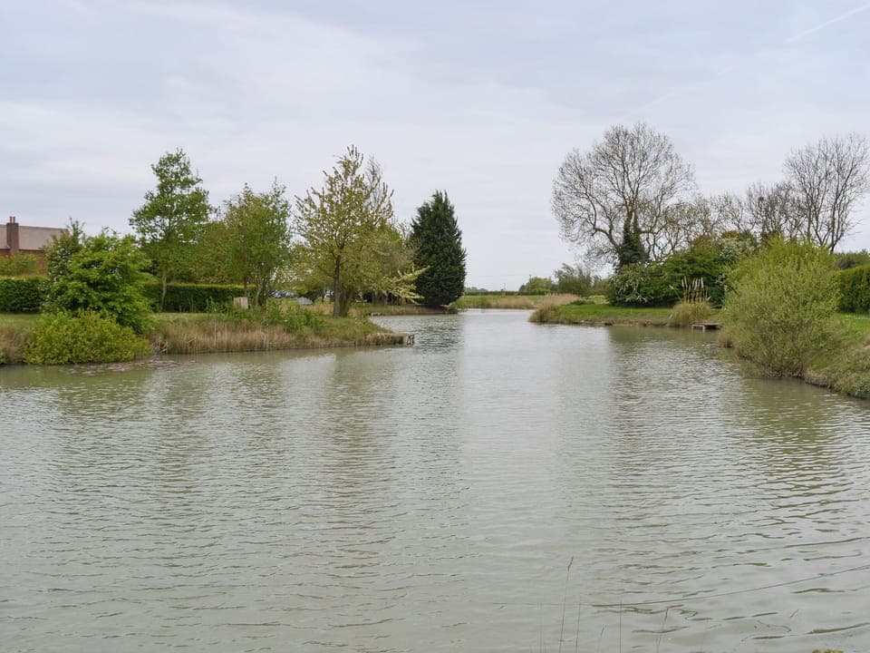 Tranquil fishing lake | Wallrudding Farm Cottages, Doddington, near Lincoln