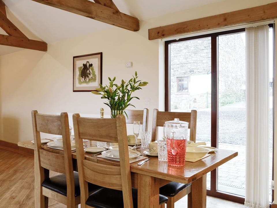 Convenient open-plan living space with access to the patio | The Old Byre - West House Farm, Dearham, near Maryport