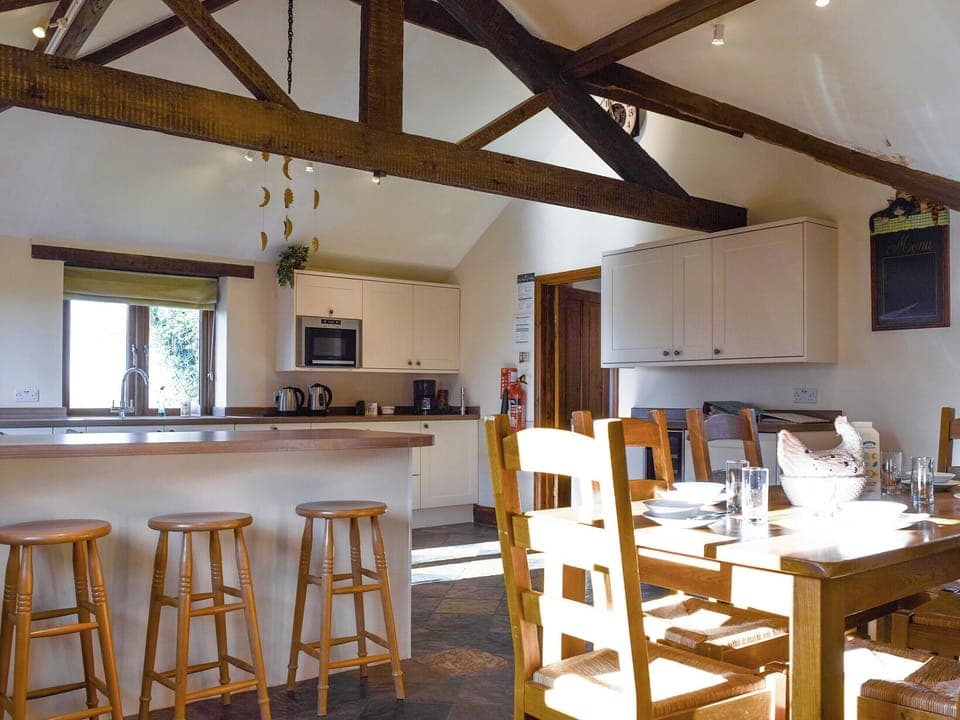 Large kitchen/diner with exposed wooden beams | Swallow Barn, Warkworth, Banbury