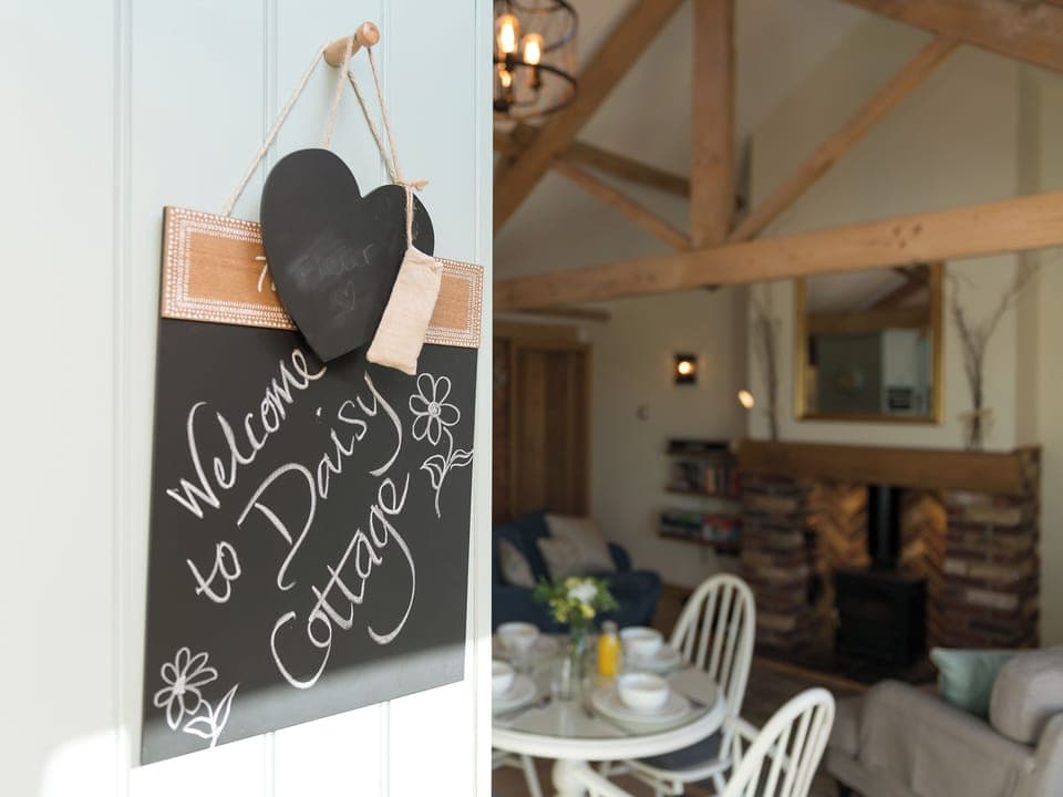 Open plan living with multi-fuel burner and wood beams | Daisy - Ham Hall Lane Cottages, Scruton, near Northallerton