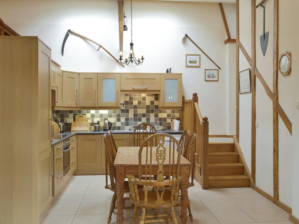 Kitchen and dining area with 4 steps to sleeping areas | Orchard View Barn - Little Clyst William Farm Cottages, Plymtree, near Cullompton