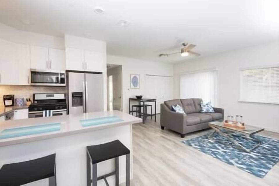 Sleek full-service kitchen seamlessly flows into the living area with access to patio and rooms.