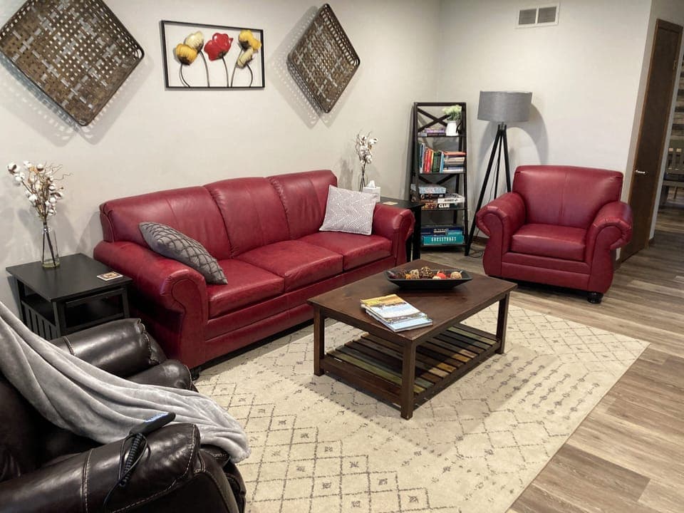 living room with power recliner, queen size sleeper sofa, smart TV and 2 chairs