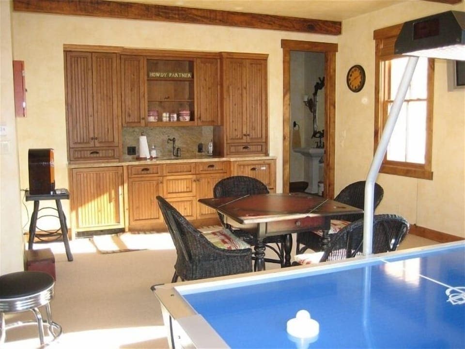 Arcade room with mini kitchen and pull out queen sofa.
