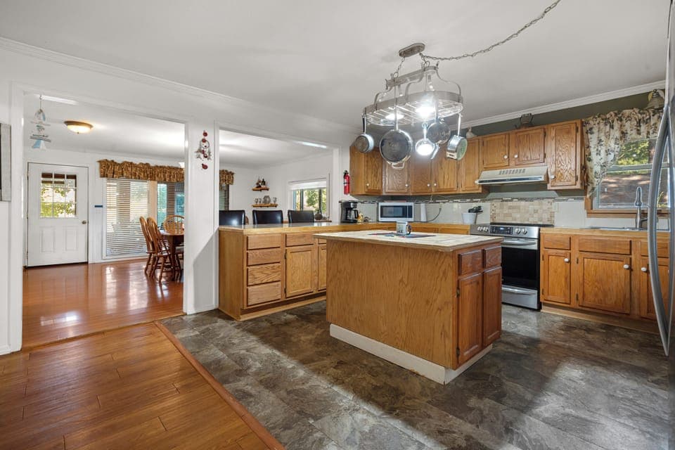 Kitchen with oven, microwave, toaster, silverware, & Pots and Pans
