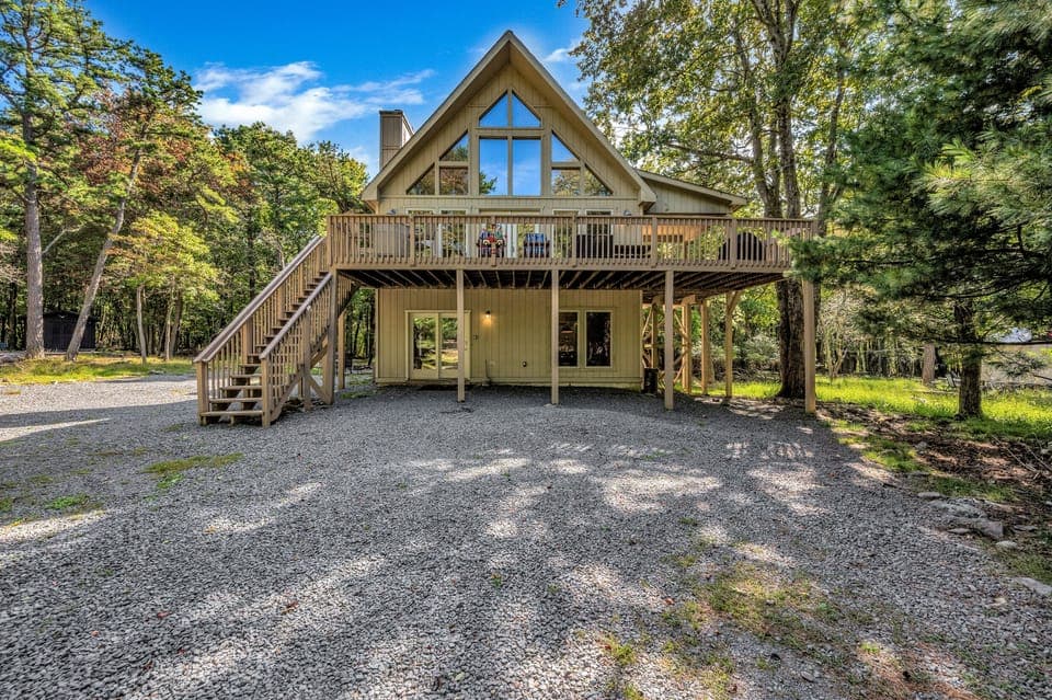 Fall view with parking area and driveway 