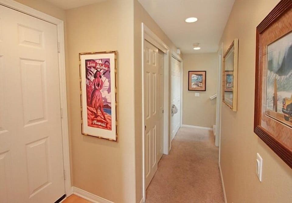 View of Hallway leading to lower Bedroom, Laundry area & stairs to upper bedroom