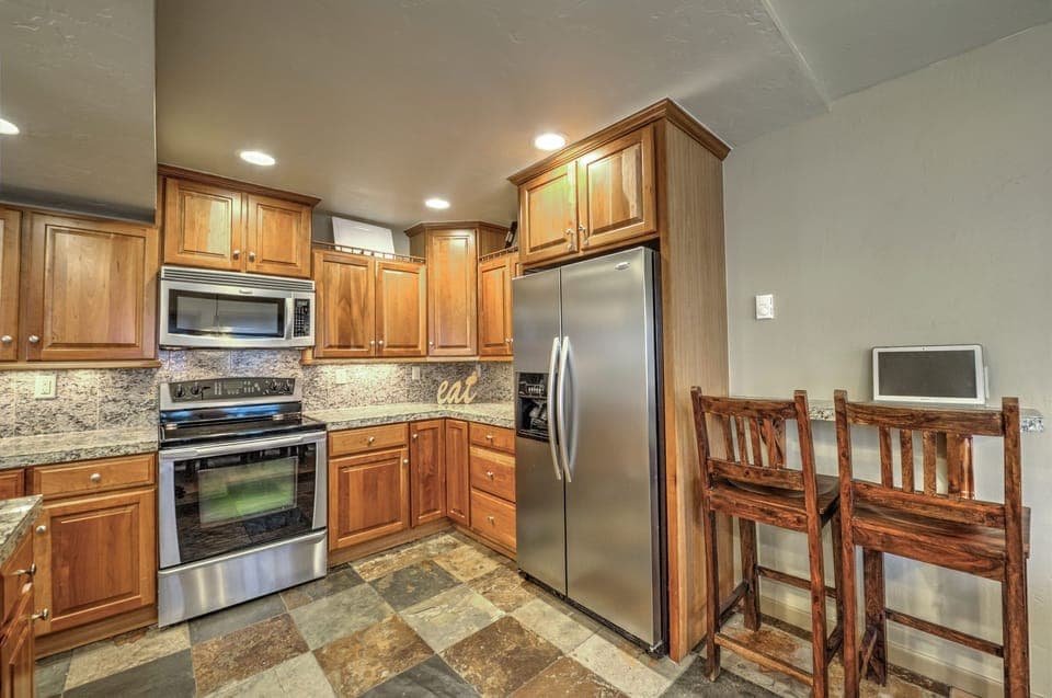 Fully Equipped Chef's Kitchen with Granite Slab, Slate Floors, and Breakfast Bar