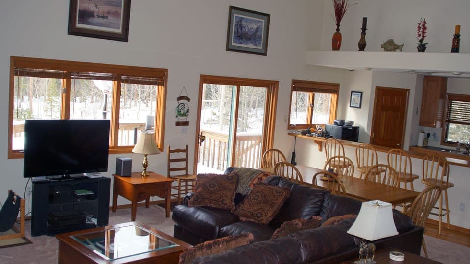 Open concept first floor with seats for 10 at the table and bar.