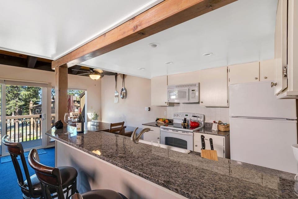 Open kitchen area with 3 barstools