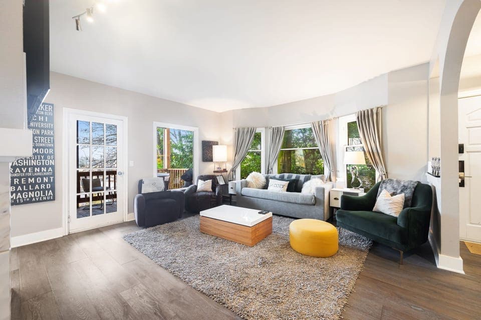 Spacious living room with pull out sofa bed and door to balcony.
