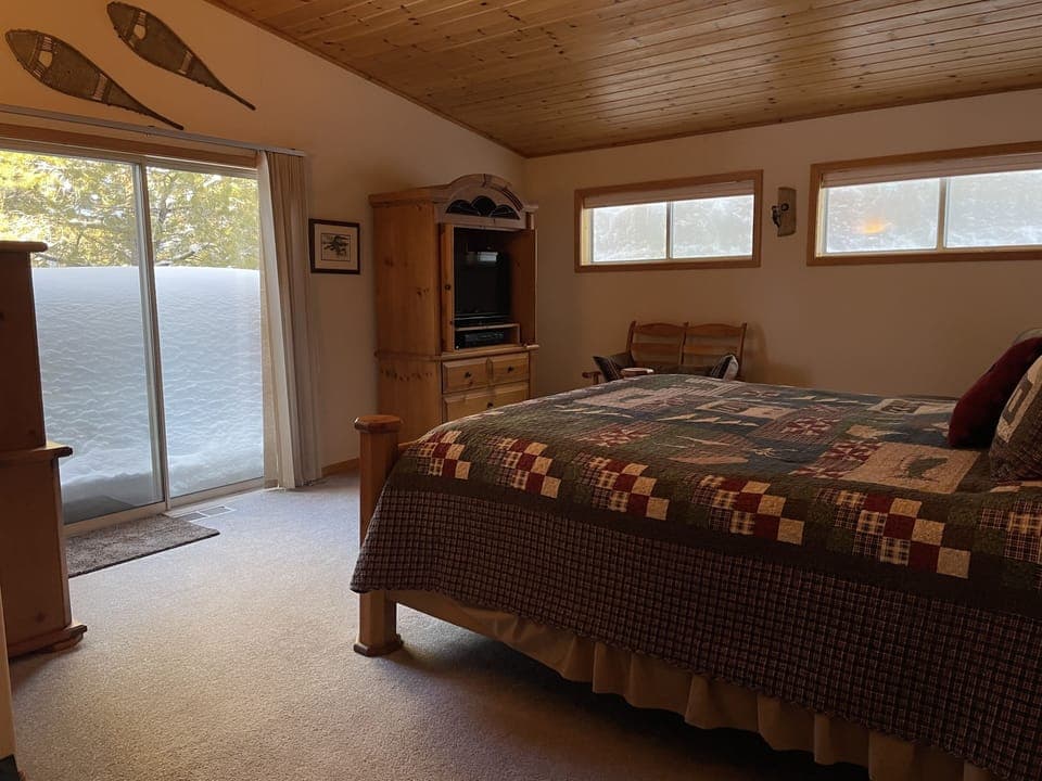 Master bedroom and deck.  TV located in armoire
