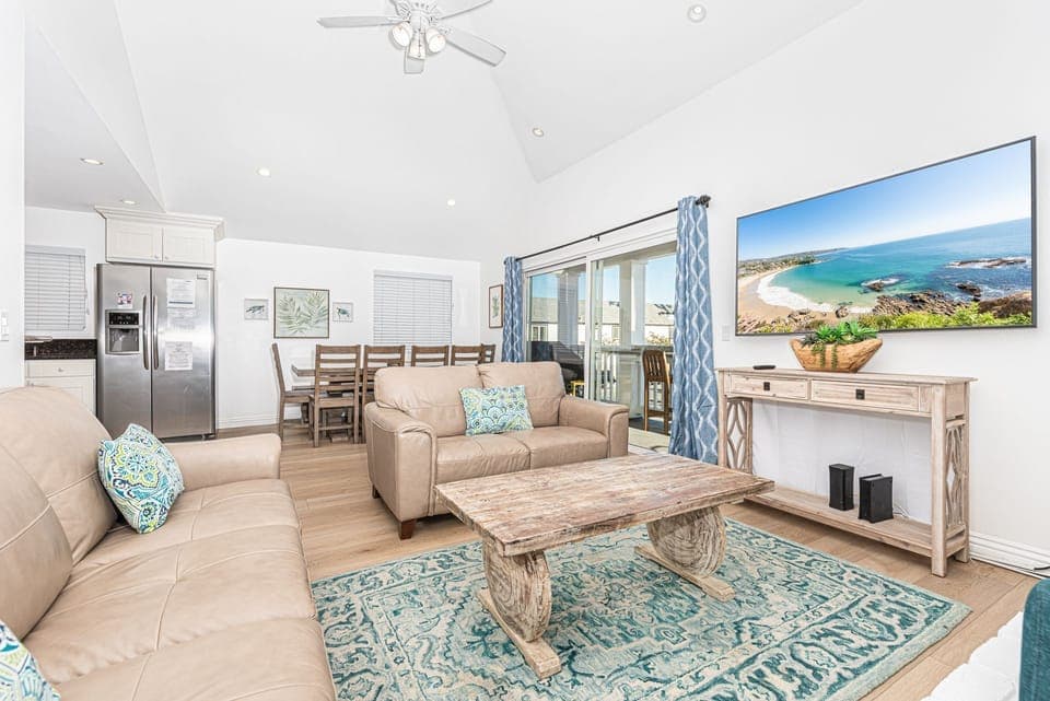 The main living area seamlessly flows from kitchen, to dining, to porch area. It includes a leather sofa set, cable TV, dining table for 6-8.
                