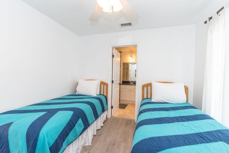 Second bedroom includes two twin beds and an en suite bathroom.
                