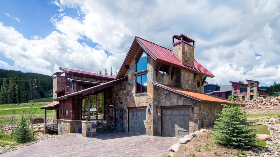 Home exterior with the Kokomo lift in the background.  Large heated driveway.