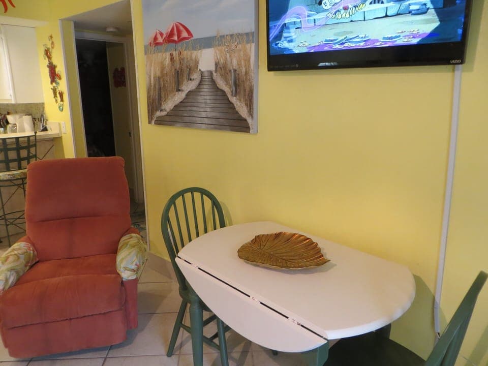 Expandable dining room table, wall mounted TV and recliner