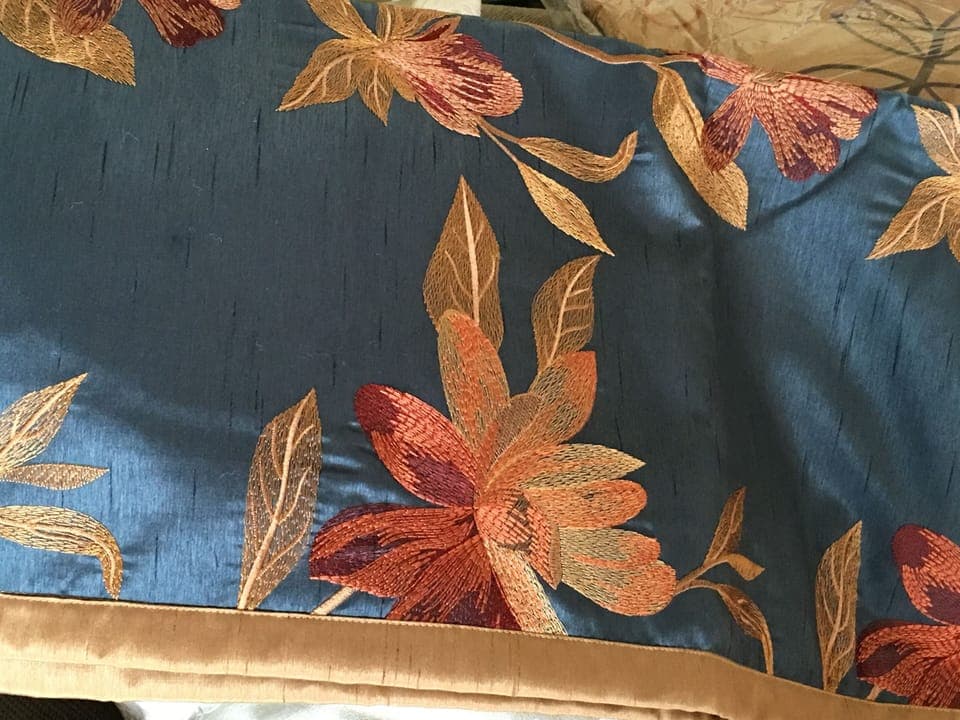 In winter we use a white duvet cover topped with an embroidered scarf (close up)