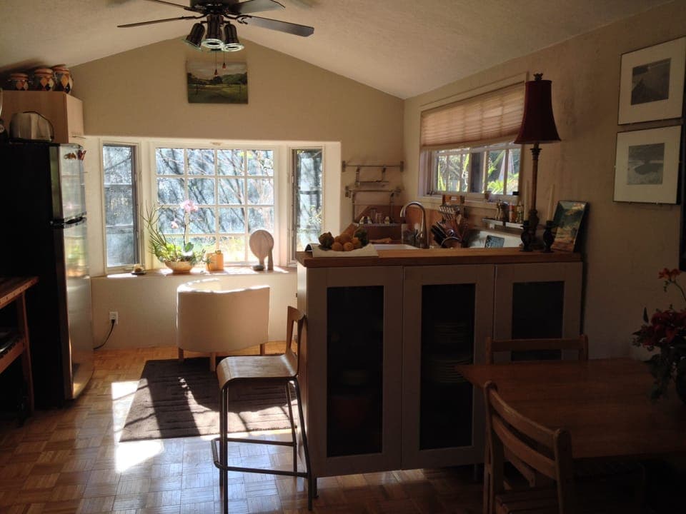 dining area with china cabinet dividing kitchen area with bay window