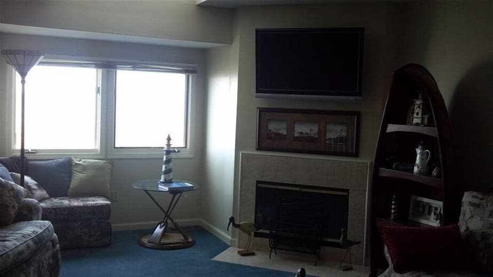 Living room with fireplace and windows looking over the lake