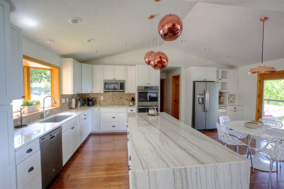Spacious open plan kitchen features a double oven.