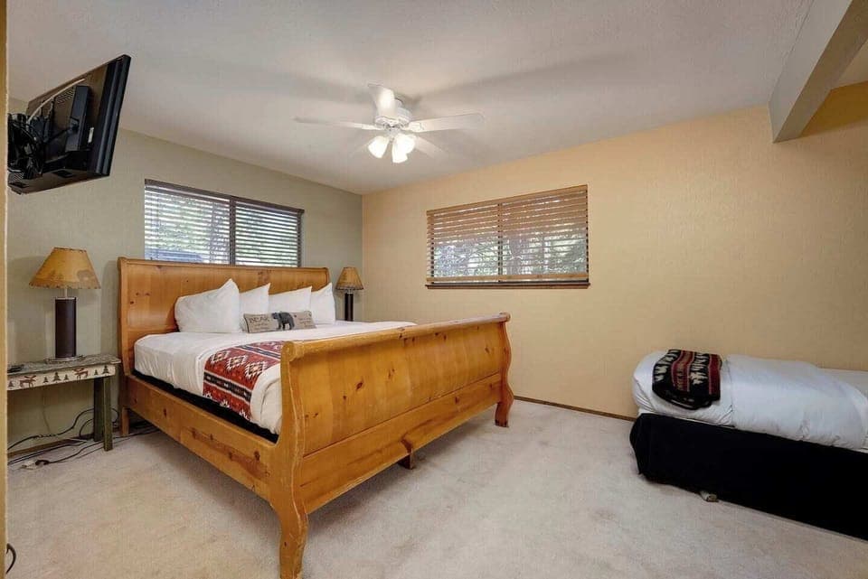 Upstairs bedroom with King bed, twin bed, TV.