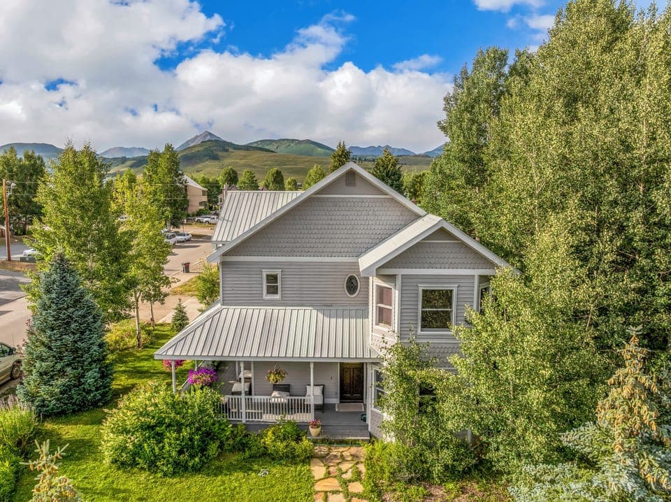 Front of house, spacious corner lot with two decks and large covered front porch