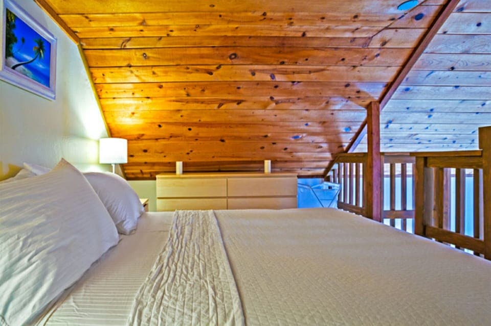 Cozy second bedroom is open to the floor below