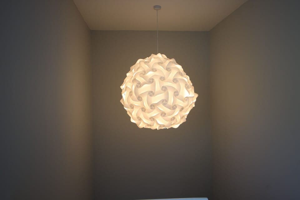 Sculptural lampshade over stairwell.