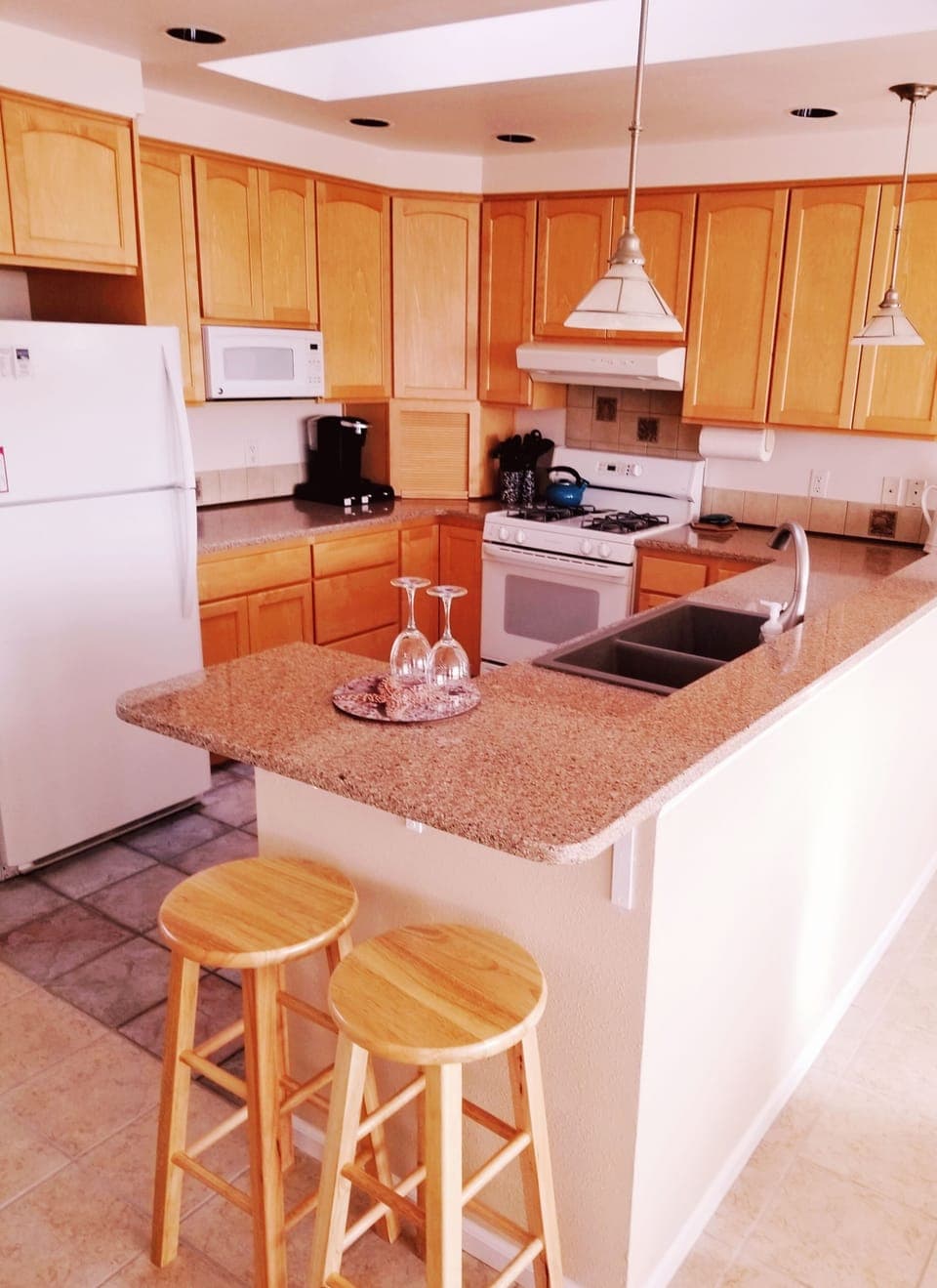 Kitchen with granite counter tops and bar area