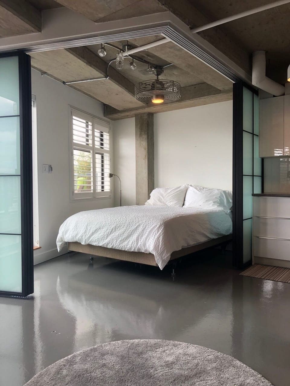 Open concept bedroom with glass sliders that give the ultimate in privacy.