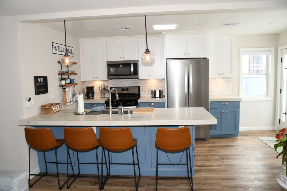 Kitchen with stove, microwave, fridge, dishwasher, toaster, and coffee maker.