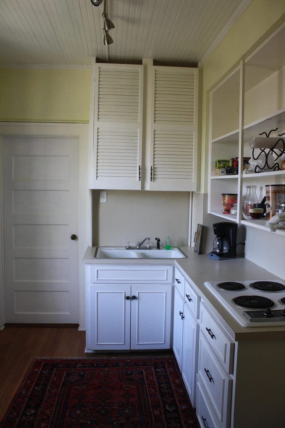 Kitchen with range, oven, sink, full refrigerator and freezer, toaster oven

