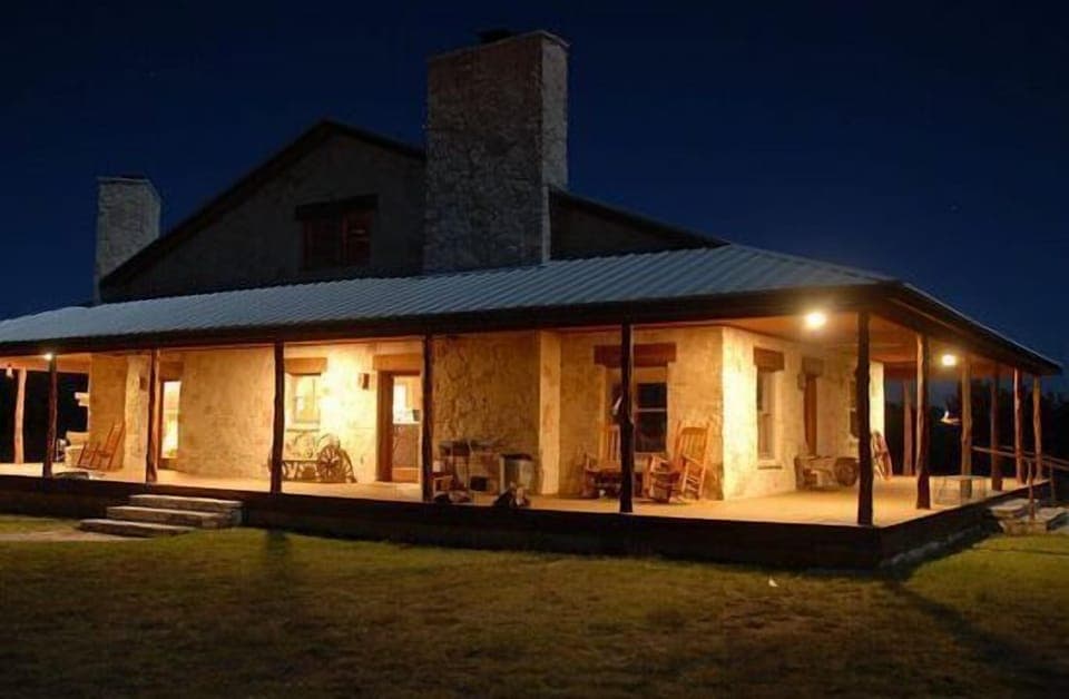 Bar None Ranch wrap around porch lit up at night. Great Place!