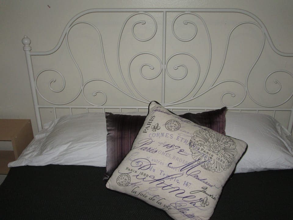 Our Mimi Room features a queen bed with a charming iron-look head and foot board