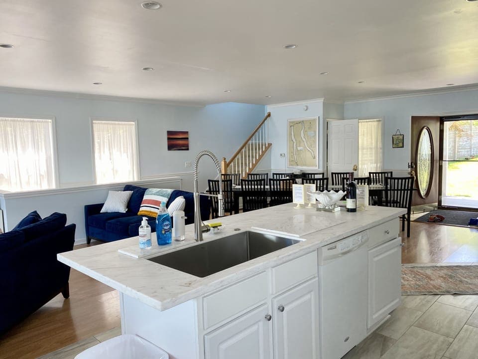 View from kitchen area overlooking living room, dining area and entryway. 