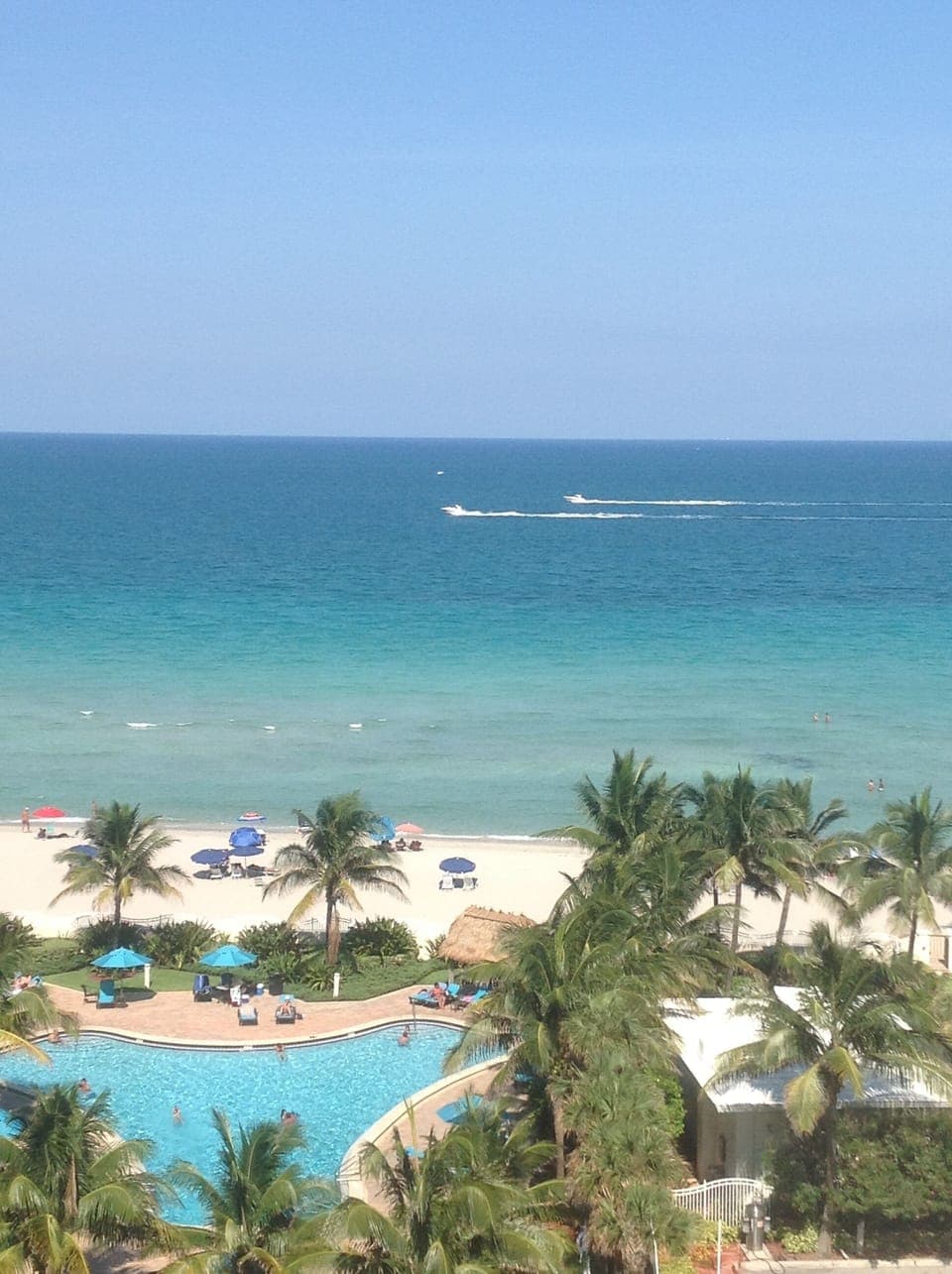 view from the balconyone of the  two swimming pools and beach.