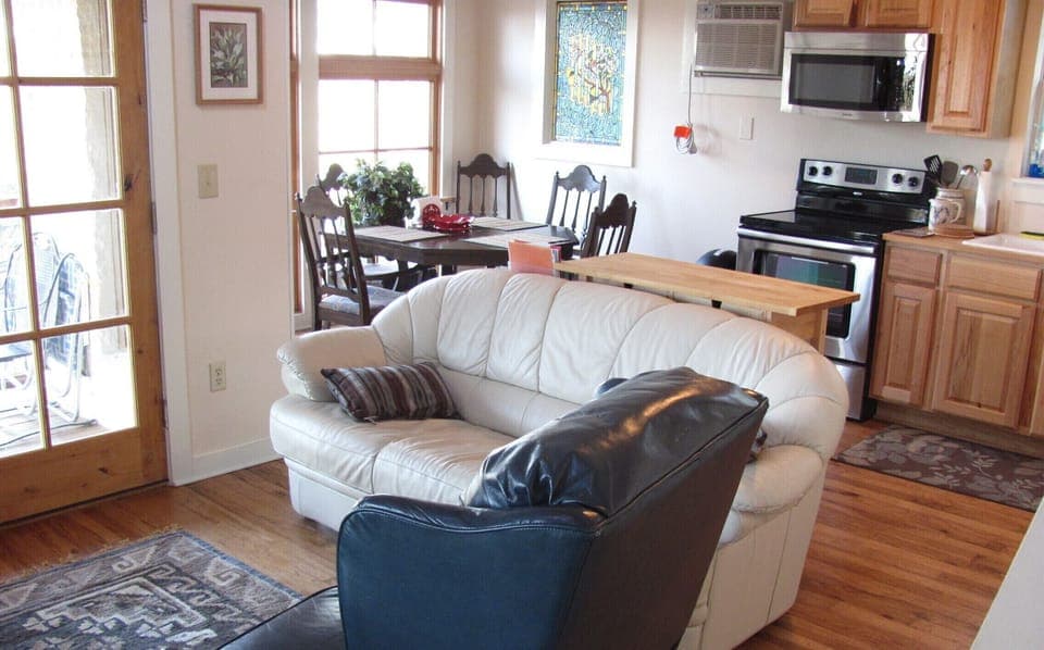 Living area with dining and kitchen in rear of photo
