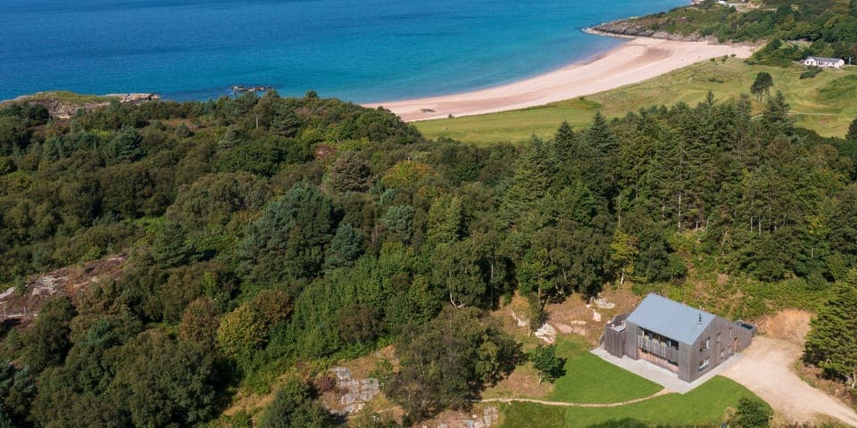 The Lighthouse is on a peninsula between Gairloch Beach and Flowerdale Bay