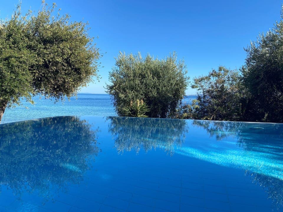 Dive into pure bliss. Infinity pool melting into the sea, the ultimate escape.