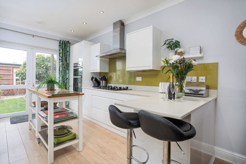 Kitchen with island looking towards the patio doors and garden beyond