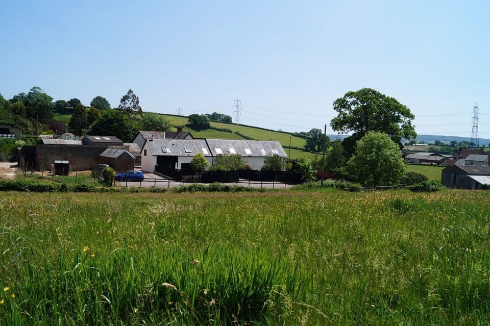 Lower Curscombe Barn, a beautiful conversion of a 400-year-old threshing barn, comprises two adjacent properties together sleeping 12