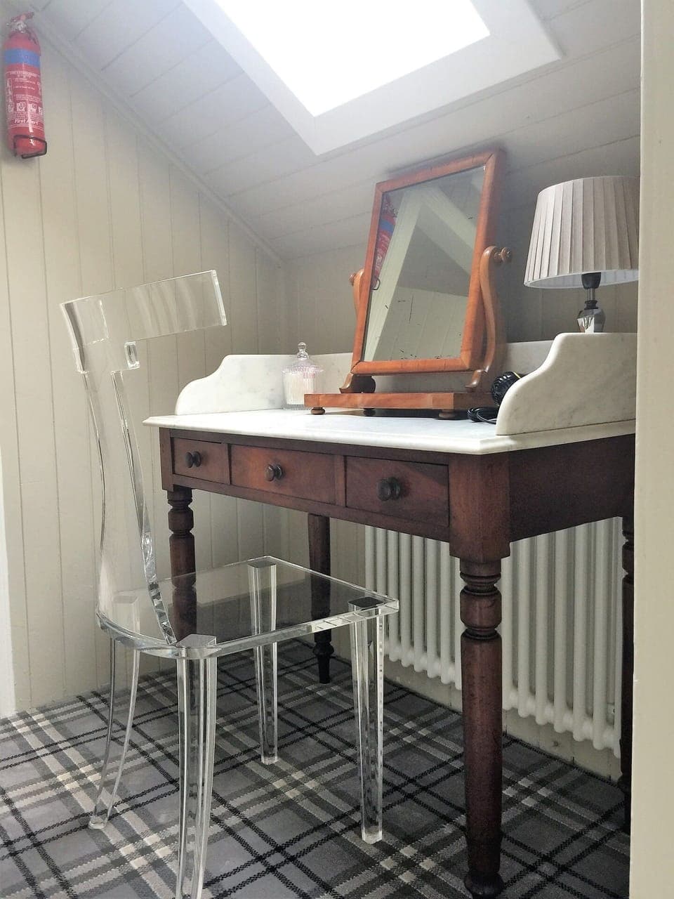 A second vanity table, with acrylic 'ghost' chair.