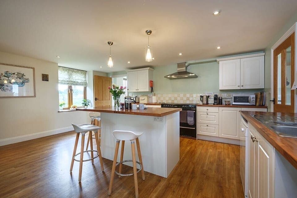 The kitchen is spacious, with island, American fridge freezer & dishwasher