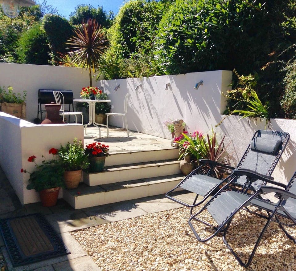 Sun trap patio with table and chairs, bbq, chiminea and sun-loungers