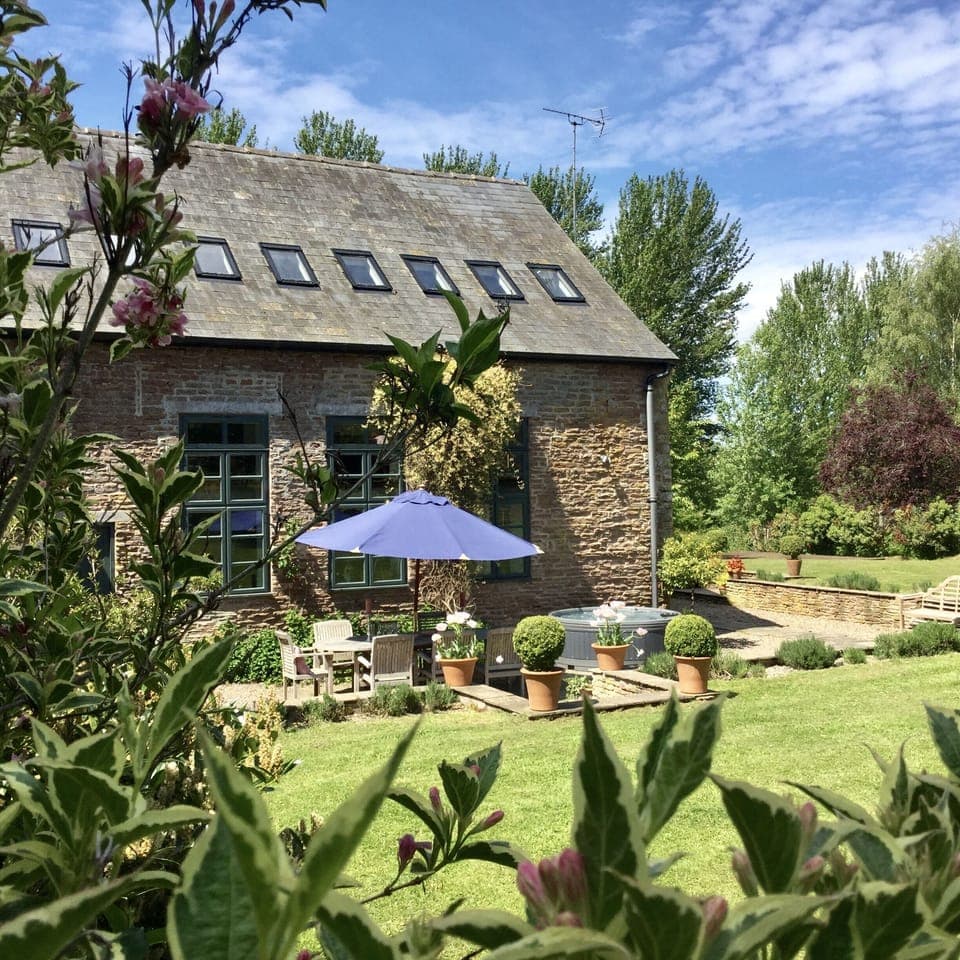 The barn is set in a large private garden.