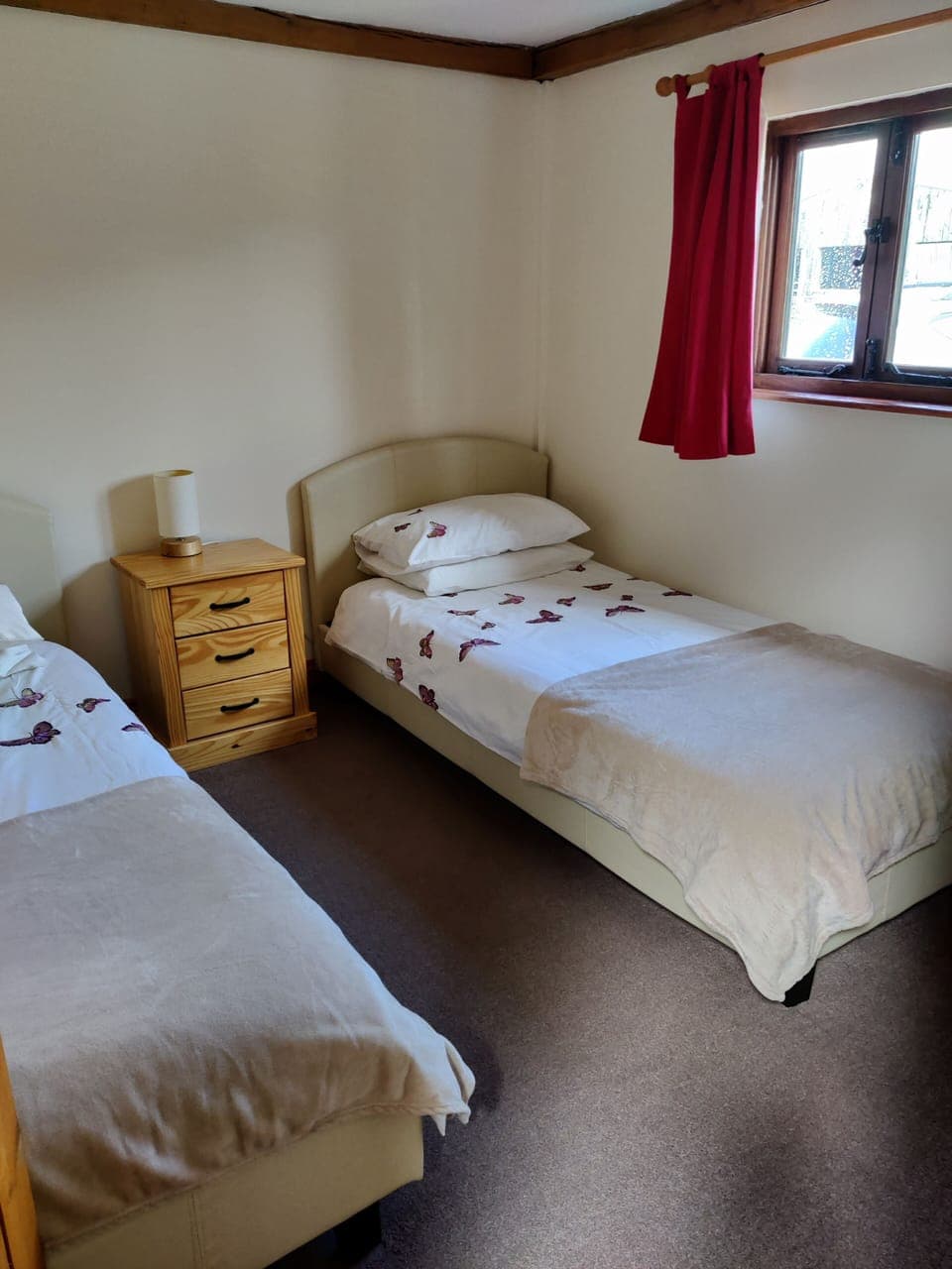 Twin room with a bedside table. Window to front