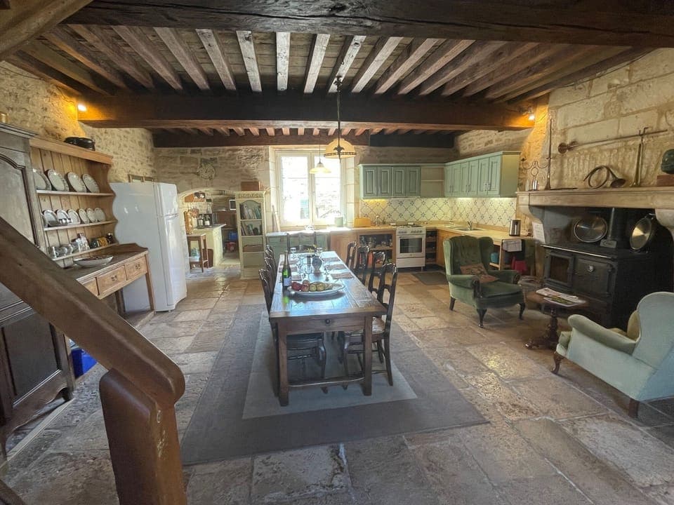 spacious kitchen dining room, massive beams, large table , woodburner