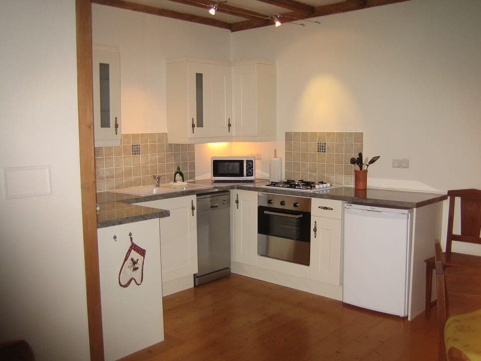 Fully fitted kitchen with modern appliances, inc dishwasher and washing machine.