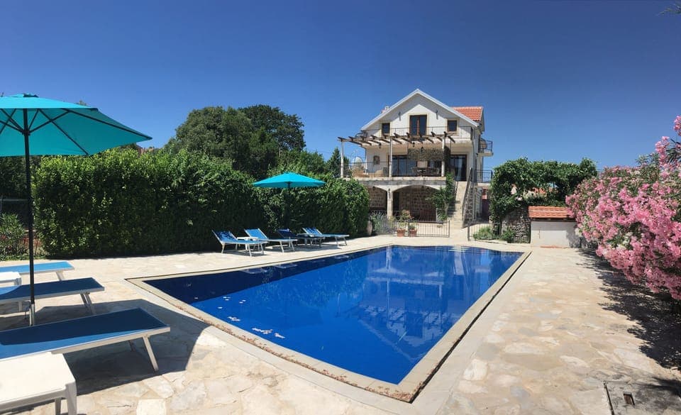 Villa over looking deck level pool with sun terraces and beautiful garden