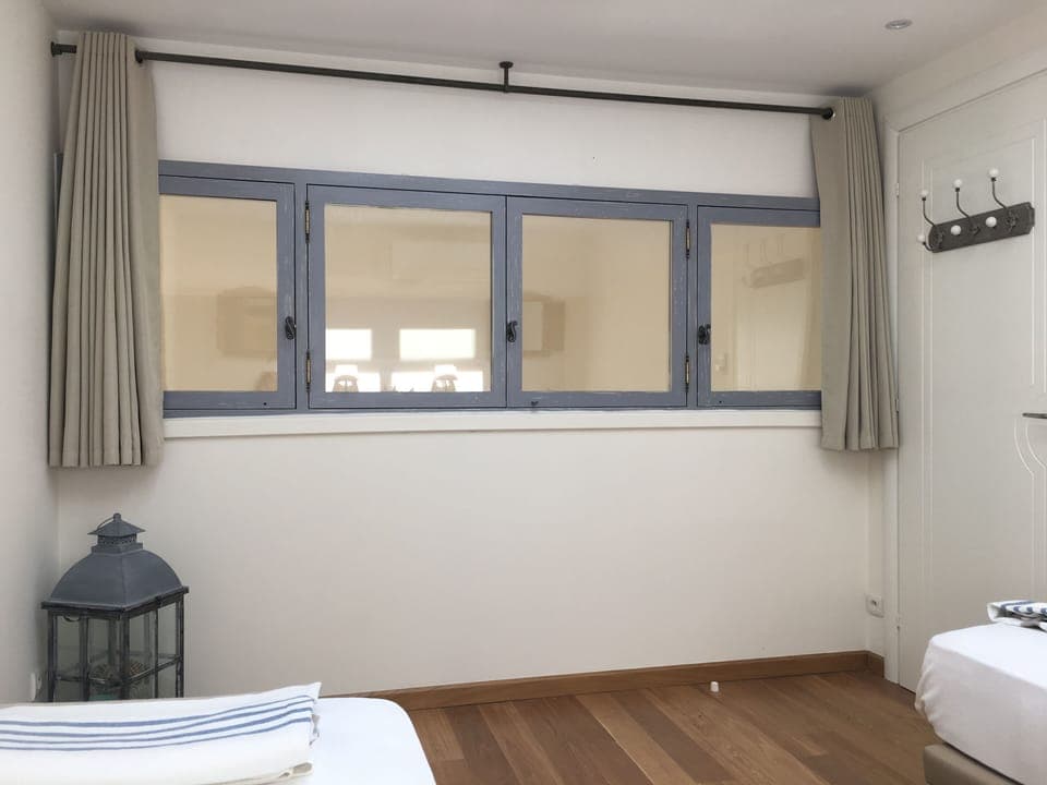 Other view of air-conditioned twin bedroom with window overlooking living area